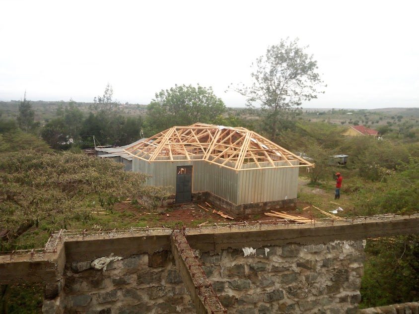 Aerial view of a hip roof frame in a rural landscape